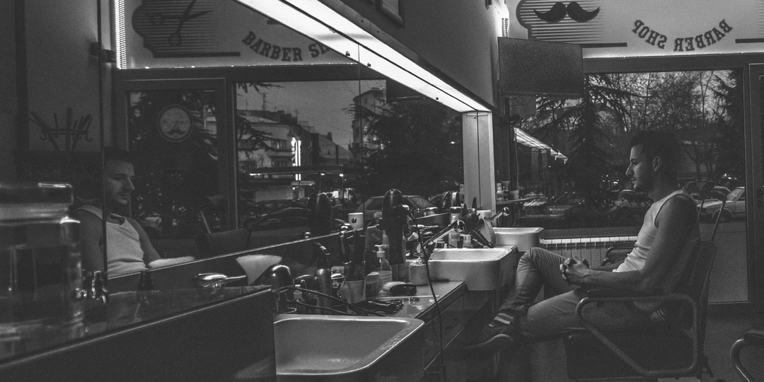 Professional barber workstation with organized storage and modern design, providing an efficient and stylish workspace for barbershop services.