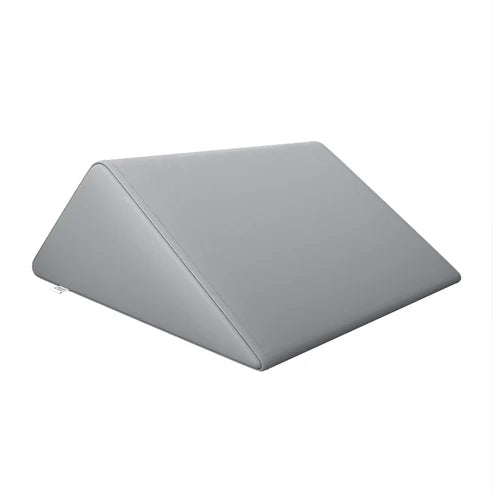 Gray triangle massage bolster wedge pillow by DIR for physical therapy and massage tables.