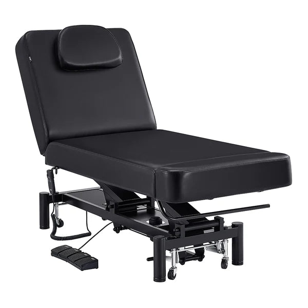 Black WellRelax 2-motor electric therapy treatment table with adjusted backrest, tilting cradle pillow, hand remote, and foot pedal controls.