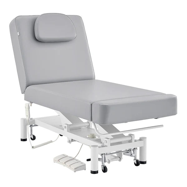 Gray WellRelax 2-motor electric therapy treatment table with adjusted backrest, tilting cradle pillow, hand remote, and foot pedal controls.
