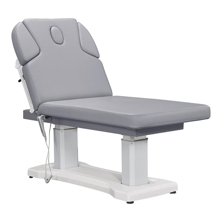 All-Gray electric facial and medical spa table with an ergonomic contoured cushion, adjustable headrest, wired hand remote, and multi-button foot control pedal.