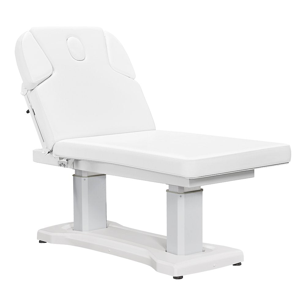 All-white electric facial and medical spa table with an ergonomic contoured cushion, adjustable headrest, wired hand remote, and multi-button foot control pedal.