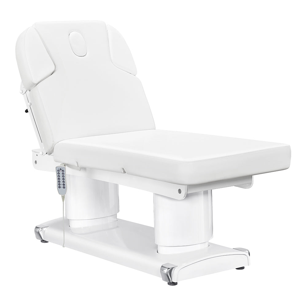 Luxi 4-motor electric medical spa treatment bed in premium white upholstery, featuring dual column lift base, hand remote, integrated foot controller, and adjustable headrest with side cushions.